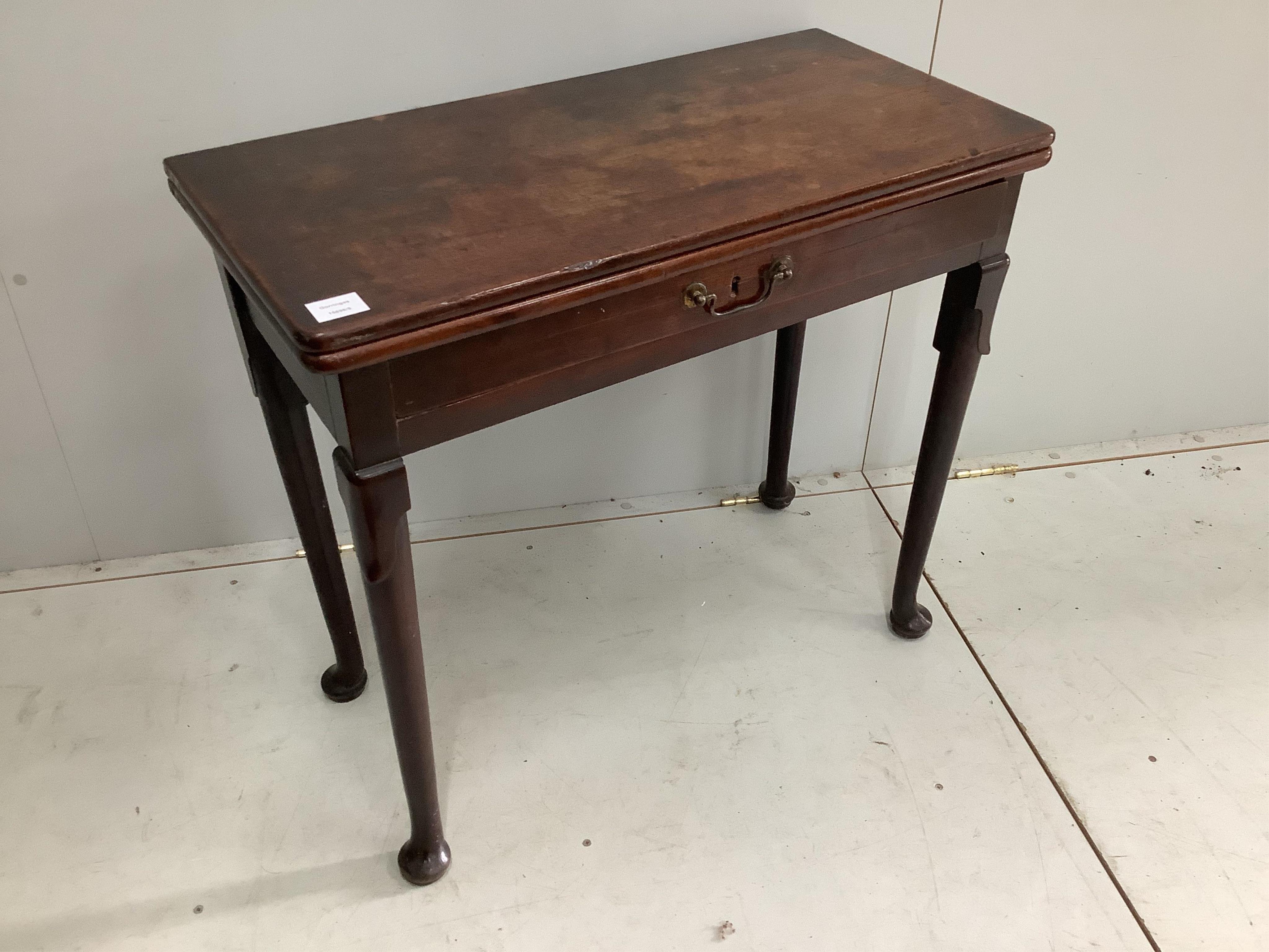 A George II mahogany folding tea table, width 81cm, height 73cm. Condition - fair to good